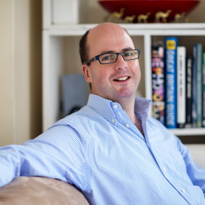 Portrait of Douglas Fry sitting on couch